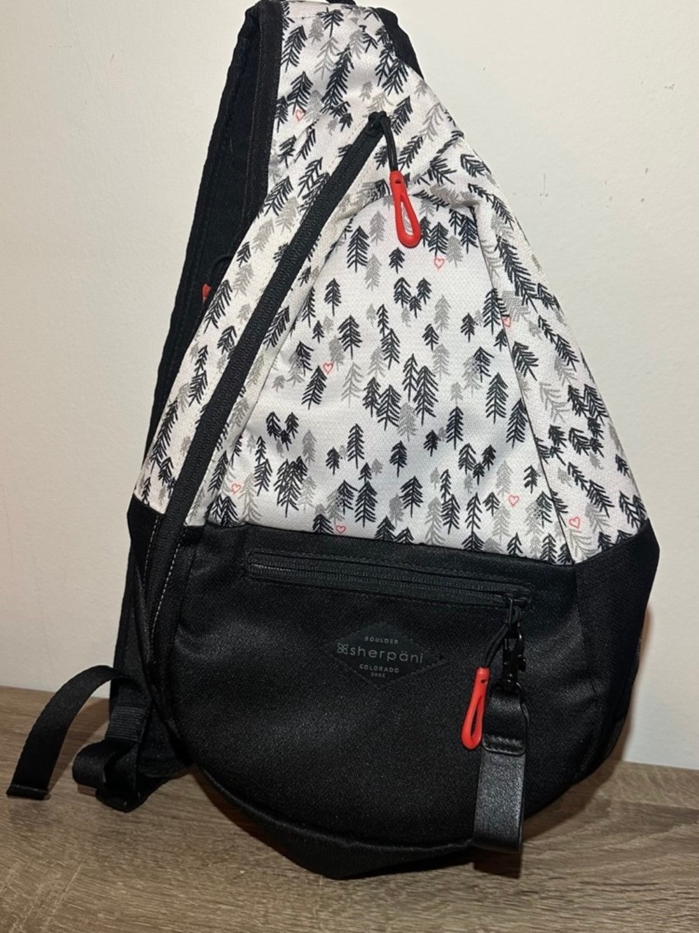 Sherpani Black & White Sling Backpack with Red Accents. Esprit